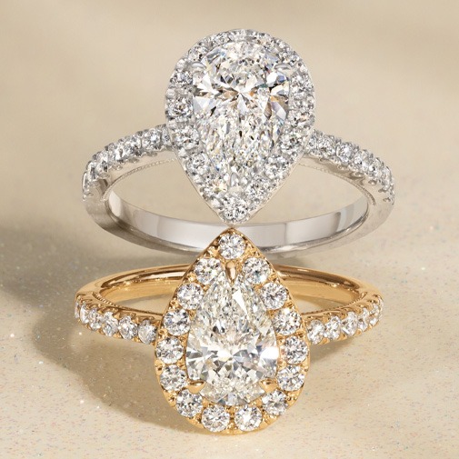 Halo engagement ring with center pear diamond surrounded by a halo of smaller diamonds