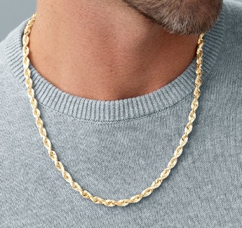 Closeup image of a man wearing a chain necklace.