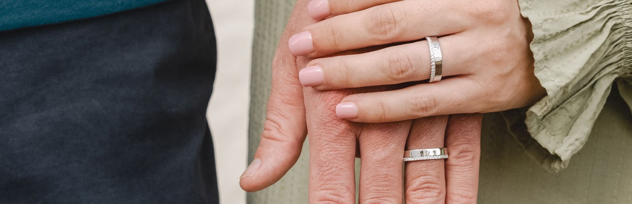 Matching Couples' Engagement Rings & Wedding Bands Couple wearing matching white gold wedding bands | men's and women's coordinating engagement rings