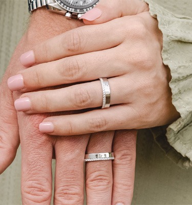 Matching Couples' Engagement Rings & Wedding Bands Couple wearing matching white gold wedding bands | men's and women's coordinating engagement rings