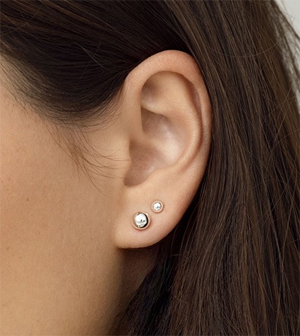 Minimal diamond stud earring stack on ear