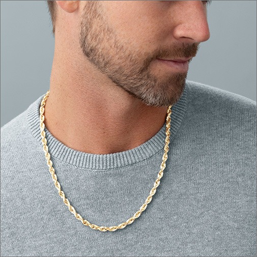Close up of man wearing a yellow gold rope chain
