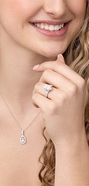 Woman smiling while wearing a Downton Abbey inspired engagement ring