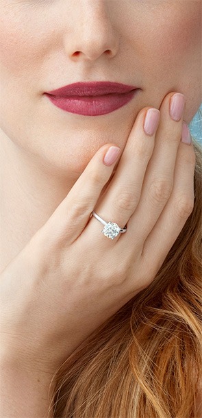 Woman wearing a Roberta Z engagement ring with diamond halo