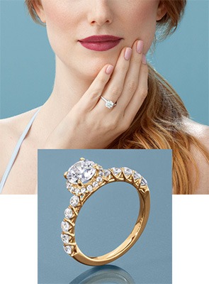 Woman wearing a Roberta Z engagement ring with diamond halo and a yellow gold diamond engagement ring