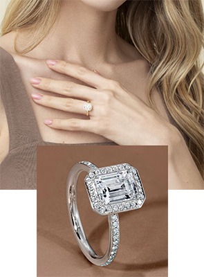 Woman wearing a Love's Path diamond engagement ring and an emerald-cut diamond engagement ring