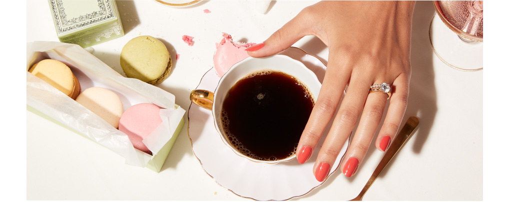 woman with Kleinfeld bridal ring and a cup of coffee at a wedding.