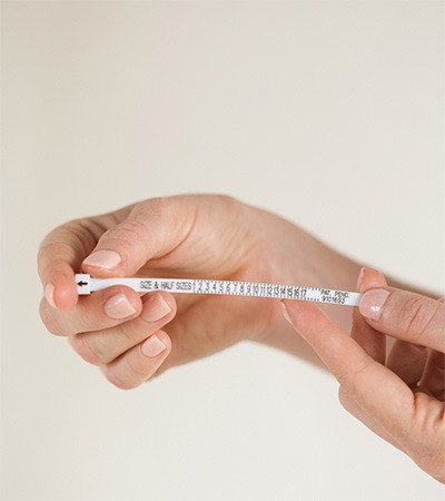 How to Measure Finger Size With a Ring Sizer Hands using a ring sizer to measure finger circumference for the correct ring size
