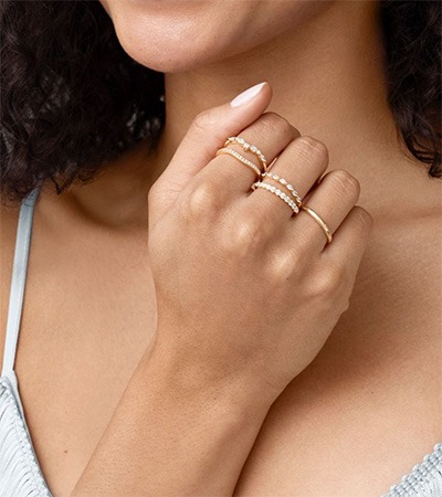 Ring Stacking Ideas for Multiple Fingers Model styling delicate gold and diamond rings across multiple fingers