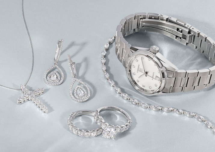 Diamond Jewelry & Luxury Watch Gifts for Weddings & Anniversaries Diamond jewelry and luxury watch gift collection featuring diamond earrings, engagement ring, cross necklace, tennis bracelet, and silver watch for weddings and anniversaries