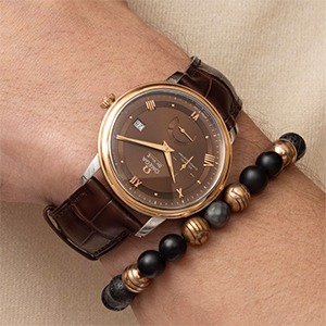 Brown leather strap watch with earth-tone bracelet styling for warm skin tones