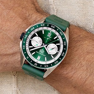 Green dial sport watch complementing warm toned skin