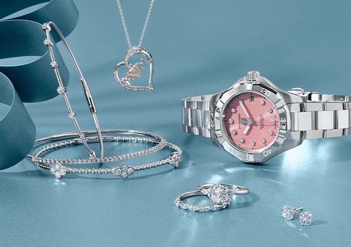 White gold diamond bangles, heart mom pendant with pink stone, diamond rings and stud earrings with Stainless Steel TAG Heuer Aquaracer with quartz pink diamond dial